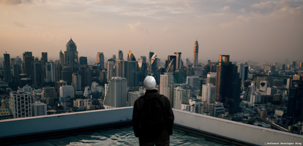 Man staring at city with many buildings